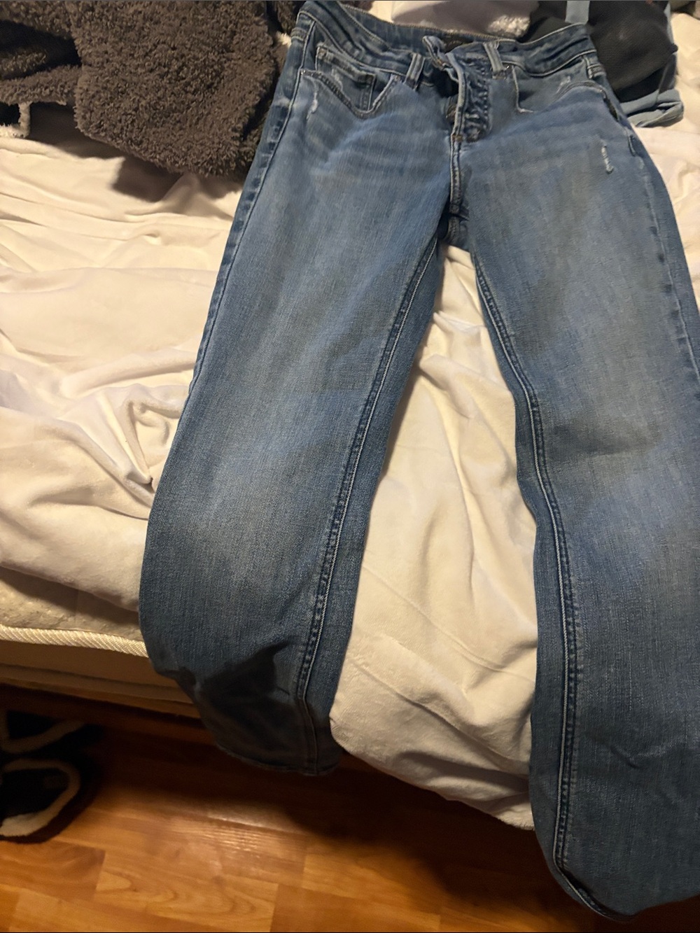 Silver Jeans medium to light blue Button-Fly Jeans for women.